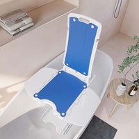 Bath lift chair raised to bath rim height in a home bathroom, ready to sit on